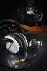 Composition with an electrical guitar and studio earphones