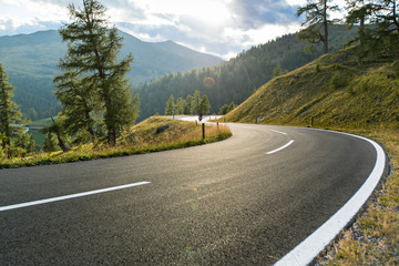 Asphalt road in Austria, Alps in a summer day. - obrazy, fototapety, plakaty