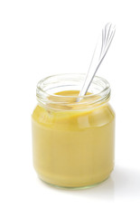 mustard sauce in jar on white