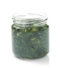 pesto sauce in jar on white