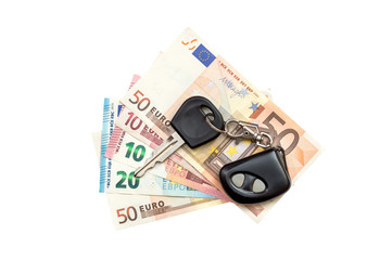 Car key with remote control on the euro bills. Isolated on white.