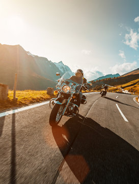 Motorcycle driver riding japanese high power cruiser in Alpine highway on famous Hochalpenstrasse, Austria.