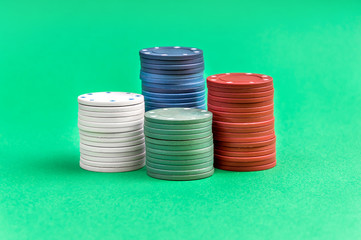 Stacks of poker chips on a green background.