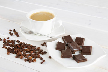 Cup of coffee and a few cups of dark chocolate. 