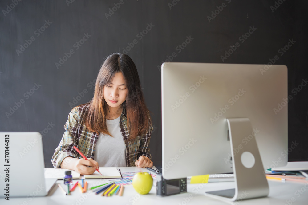 Aufkleber graphic designer using digital tablet and computer in the office