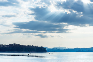 Fototapeta na wymiar Cloudscape with sunlight over the lake.