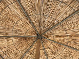 Straw umbrellas on a beach. Suitable to be used like a background.