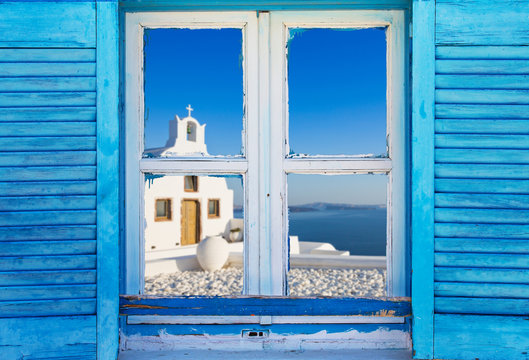 Beautiful vintage Greek window with blue shutters. Typical Greek picture.