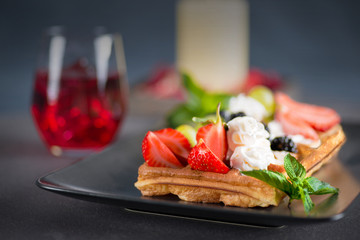 wafers with berries and cream on a plate