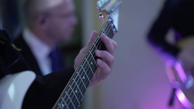 Guitarist in music band at concert