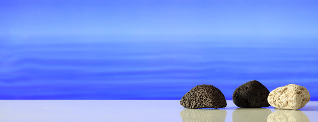 Pumice rocks on blue sea background