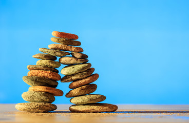 Zen stones stack on blue background