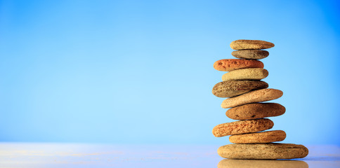 Zen stones stack on blue background