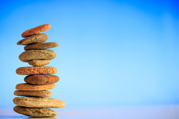 Zen stones stack on blue background