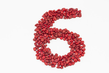 The number six, made by red stones.