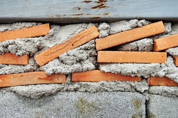 sloppy red brick wall.