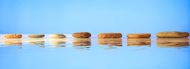 Zen stones row on blue background