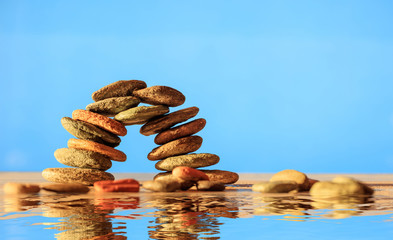 Zen stones stack on blue background