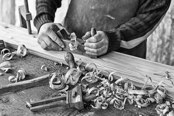 craftsman smooth a wooden board