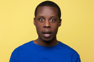 Astonished African American. Surprise emotion. Shocking news for black man, handsome male portrait,...