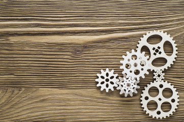 Gear wheels on wooden background. The concept of creative, logical thinking.
