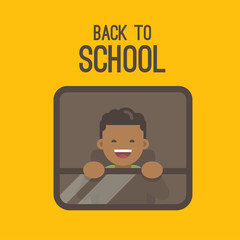 A little boy looking out the window of a yellow school bus. Back to school