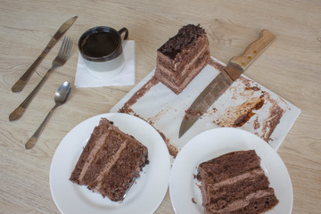 Coffee cup and chocolate cake onon wooden table