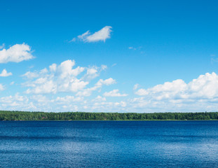 A natural landscape with a lake and clouds