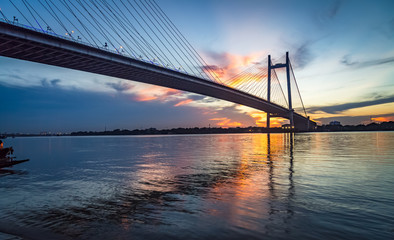 Vidyasagar Setu - the cable stayed bridge on river Hooghly at sunset with water reflections