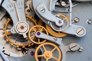 Clock transmission macro view. Stopwatch chronometer mechanism cogs gears wheels connection...