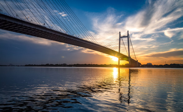 Fototapeta Vidyasagar Setu - the cable stayed bridge on river Hooghly at sunset with moody sky.
