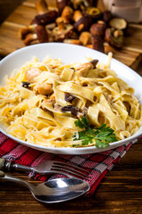 Tagliatelle pasta with forest mushrooms and chicken.