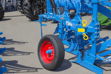 Fragment of a tractor for agricultural works. In the foreground wheel.