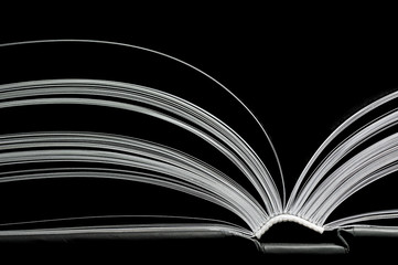 A black and white image of open book. Close-up image of  double-page spread on black background. Concept of gaining knowledge, learning, typography, passion for reading - obrazy, fototapety, plakaty