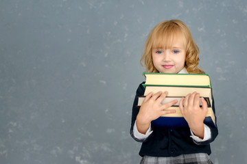 Little girl hugging an old book, he is happy. International children's book day.