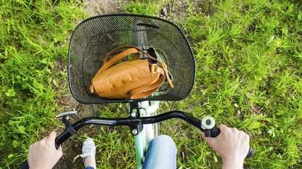 Hands of a girl on a bicycle handlebars