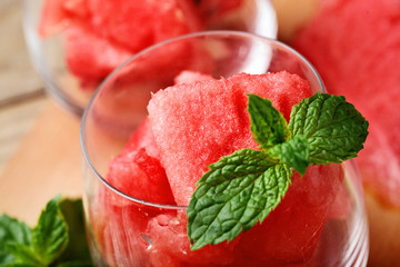 Watermelon. Closeup watermelon cut into cubes in glasess decorated with mint. Selective focus.
