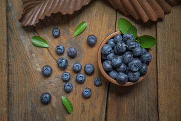 fresh bilberries or blueberries in small wooden bowls