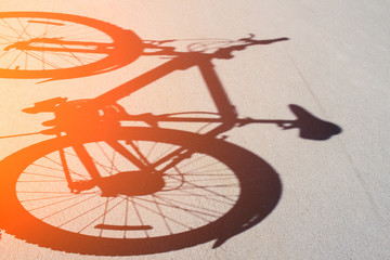 Fototapeta na wymiar Shadow of a bicycle on the asphalt toned