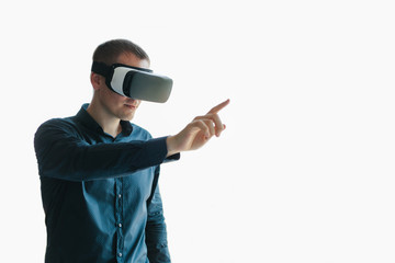 Young man with virtual reality glasses. Modern technologies. The concept of future technology.
