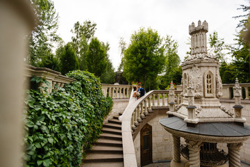 beautiful groom and the bride on a staircase in the palace