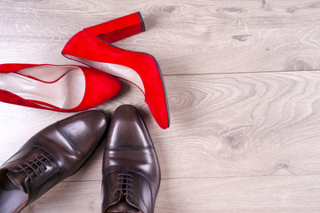 men's and red high heel womens shoes on white background