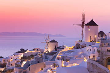 The famous sunset at Santorini in Oia village - obrazy, fototapety, plakaty
