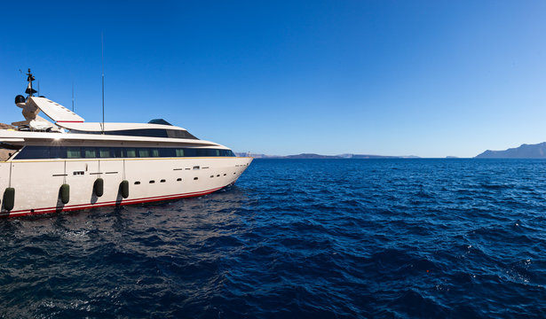 Luxury boat in deep blue water, Santorini, Greece.
