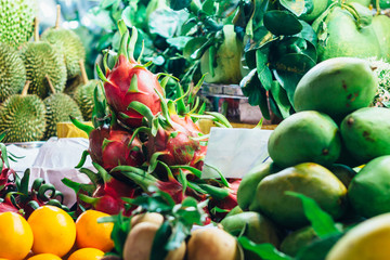 Mango, dragon fruit, durian and oranges on a fresh fruit stall at the local market in Ho Chi Minh city (Saigon), Vietnam