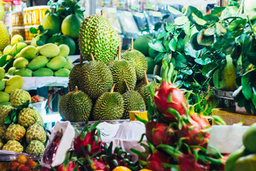 Mango, dragon fruit, durian and oranges on a fresh fruit stall at the local market in Ho Chi Minh city (Saigon), Vietnam