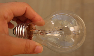 woman hand holding light bulb