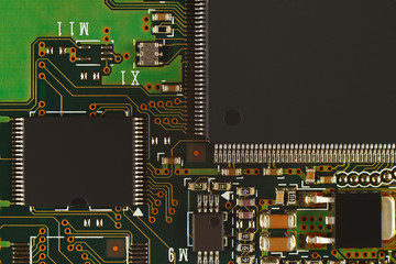 Microelectronic circuit with digital microchips board close up.
