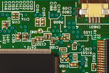 Modern microelectronic circuit board with components close up.