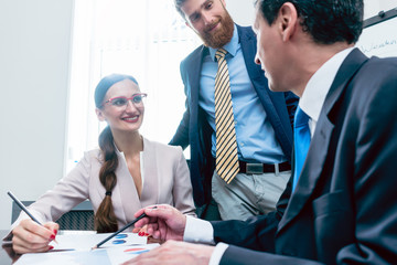 Business analyst smiling while interpreting financial reports showing profit and development during...